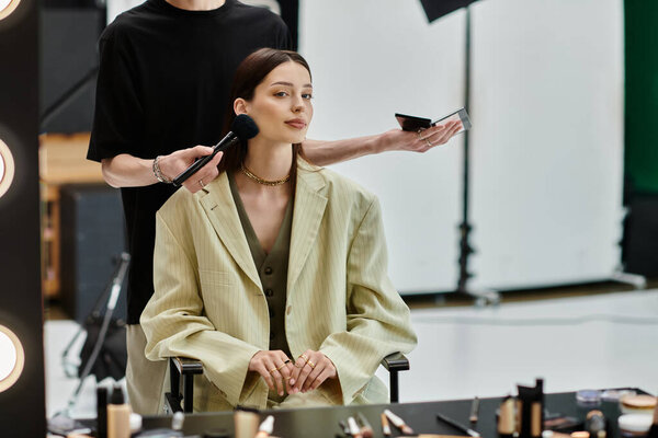A woman sits before a mirror as an artist creates a stunning look.