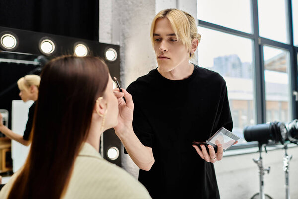 Woman getting makeup done by professional artist in front of mirror.