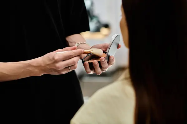 stock image Professional stylist applying makeup on woman.