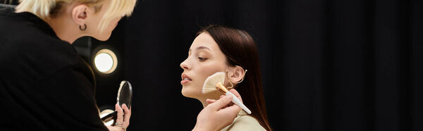Appealing woman enjoying makeup session with stylist.