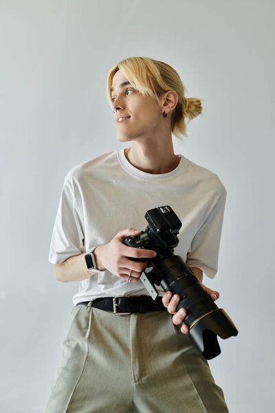 A man holding a camera and gazing away.