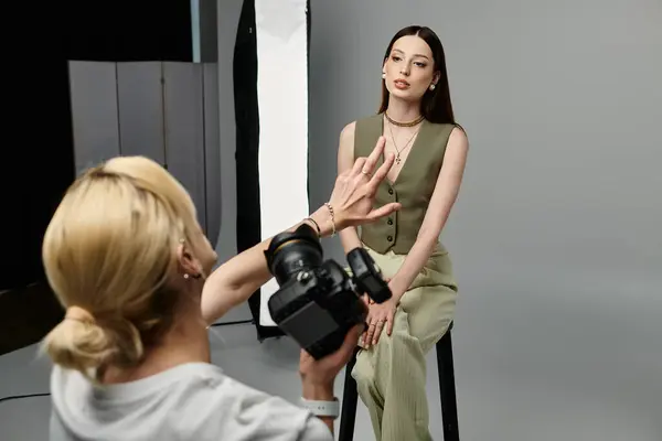 stock image Attractive man taking photos of young woman on camera.