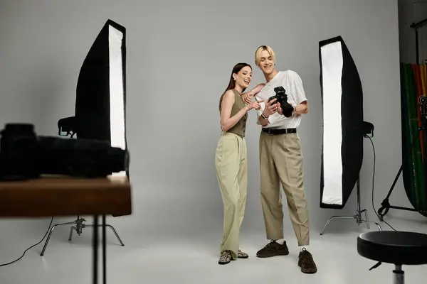 stock image A man photographs a woman in a captivating moment.