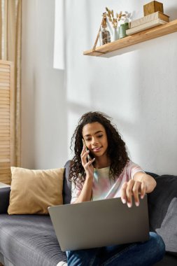 Woman on couch chatting on phone. clipart