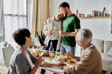 A gay couple celebrates with parents over a home-cooked meal. clipart