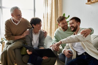 A gay couple shares a laugh with parents while looking at a photo album. clipart