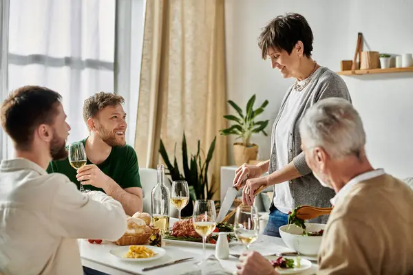 stock image A gay couple enjoys dinner with parents at home.