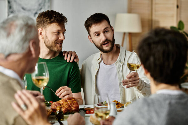A gay couple enjoys a meal with their family at home.