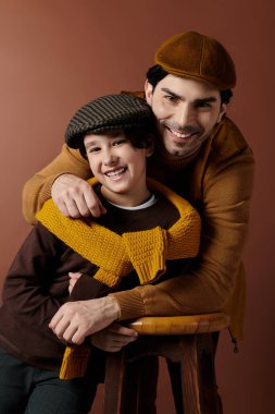 A father and son share a warm embrace, their smiles radiating happiness and love. clipart