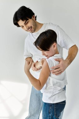 A father and son share a tender moment, the father smiling down at his child. clipart