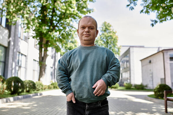 A man with inclusivity standing on a city street, smiling and looking at the camera.