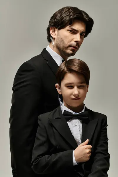 stock image A father and son in matching suits, a moment of quiet bonding.