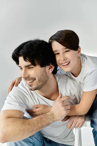 Stock image A father and his son share a moment of joy and affection.