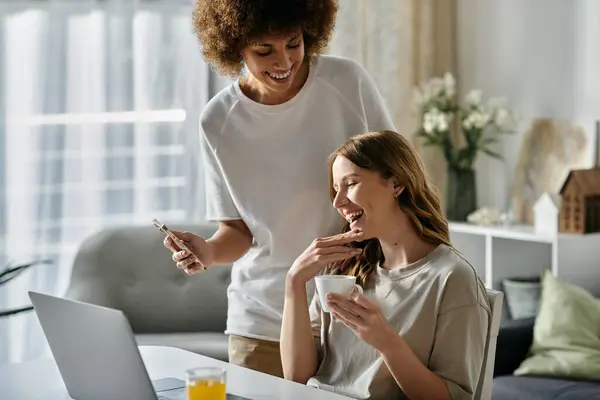 stock image A diverse lesbian couple enjoys a cozy morning together at home.