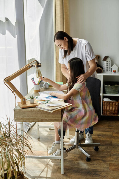 A brunette mother and her daughter, who has a prosthetic leg, are spending quality time together at home.