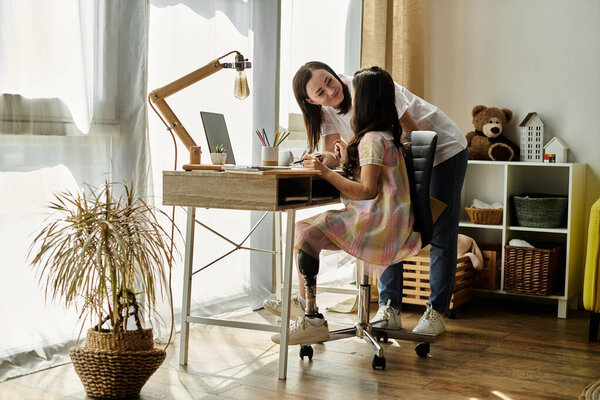 A brunette mother helps her daughter, who has a prosthetic leg, with schoolwork at their home.