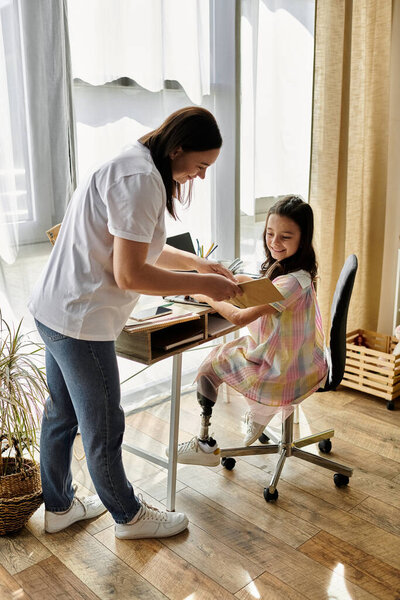 A brunette mother and her daughter, who has a prosthetic leg, are spending time together at home.