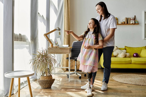 A mother and daughter spend quality time together in their home. The young girl has a prosthetic leg and her mother supports her lovingly.