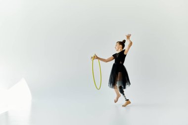 Protez bacaklı genç bir jimnastikçi halkayla zarif bir gösteri sergiliyor..