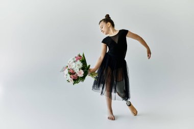 A young girl with a prosthetic leg performs a graceful dance move while holding a bouquet of flowers. clipart