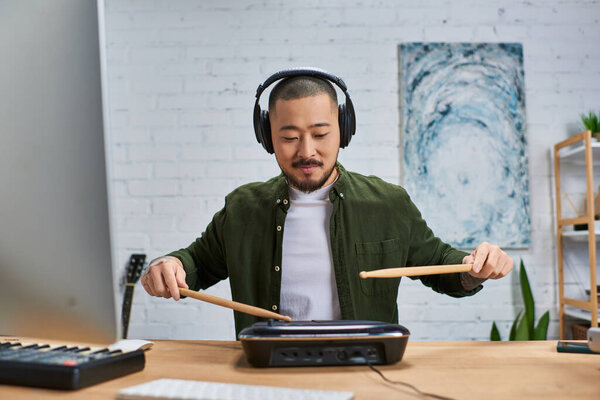 Человек играет на барабанах в своей студии, создавая ритмы и музыку.