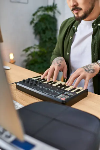 stock image A close-up of a mans hands playing a MIDI keyboard in his studio.