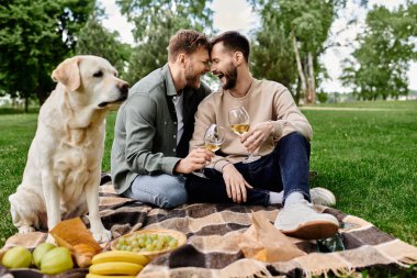 A bearded gay couple enjoys a picnic with their labrador in a green park, sharing a toast and a laugh. clipart