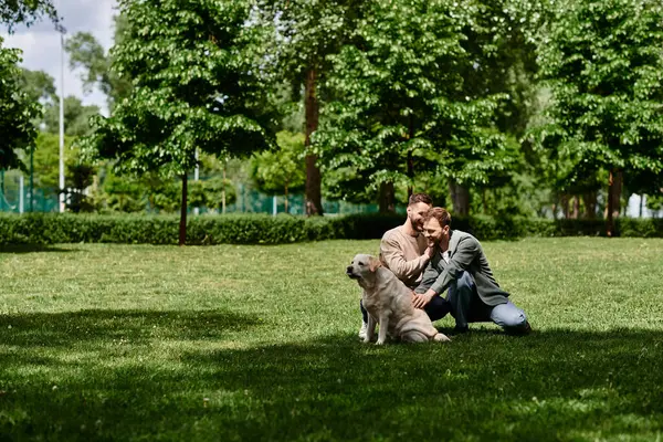 stock image A bearded gay couple enjoys a sunny day in the park with their labrador retriever.