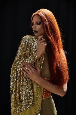 A glamorous drag diva poses in a dazzling gold sequined outfit. clipart