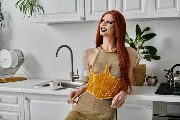 stock image A glamorous drag queen poses in a kitchen, showcasing her stylish attire.