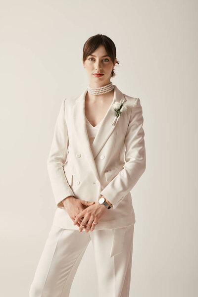 A beautiful young bride poses in a classic white wedding gown, exuding elegance and style.