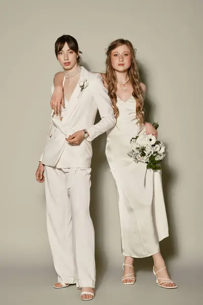 stock image Two women in white attire pose for a wedding portrait, celebrating their love and commitment.