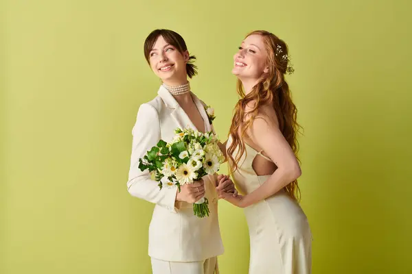 stock image Two brides in white attire smile brightly during their wedding ceremony, symbolizing love and acceptance.