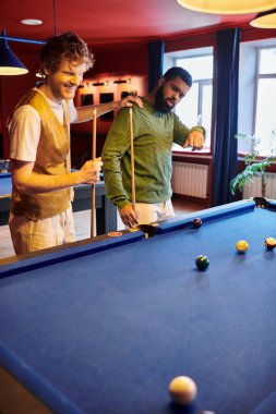 Arkadaşlar sıradan bir ortamda dostça bilardo oynarlar..