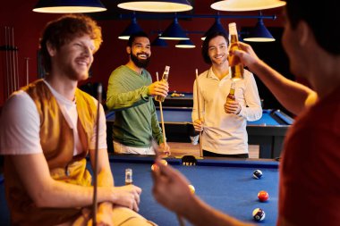 Friends enjoy a casual night out, laughing and playing billiards with beers in hand. clipart