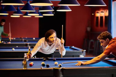 Friends play pool in a dimly lit room, enjoying a friendly game with beers. clipart