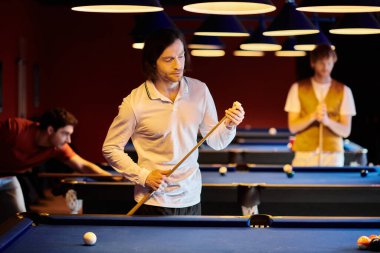 Friends play a friendly game of billiards in a dimly lit room. clipart