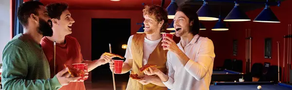 stock image Friends gather around a billiard table, laughing and enjoying a casual game.