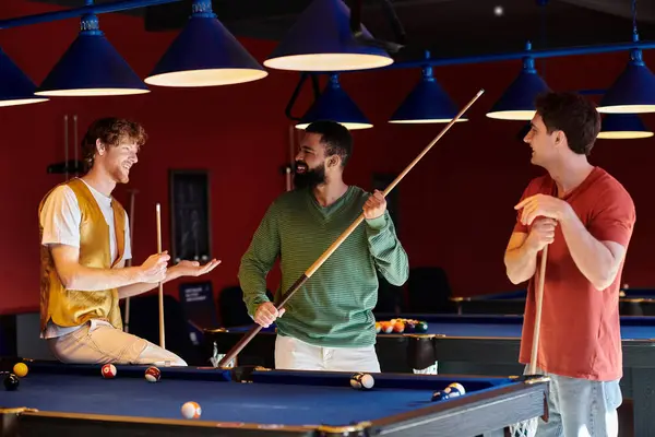 stock image Friends gather around a pool table, laughing and enjoying a casual game of billiards.