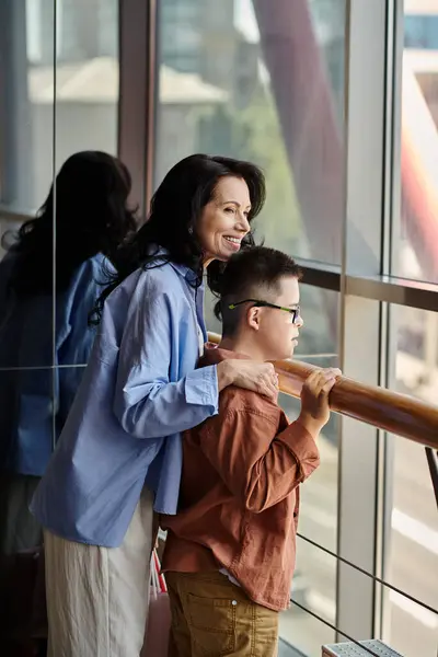 stock image A mother and her son with Down syndrome share a moment while window shopping at the mall.