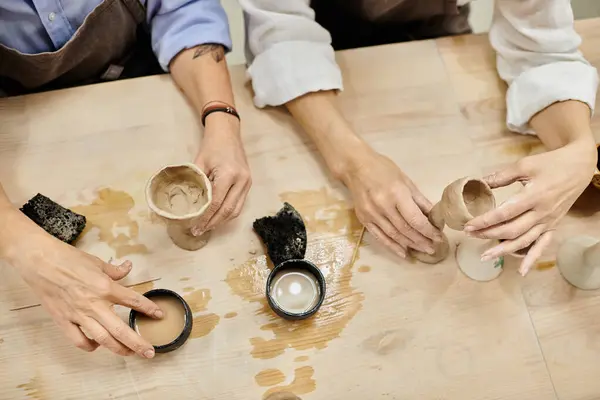 stock image A lesbian couple works on pottery projects in a cozy studio setting.