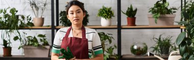 A young Asian woman, the owner of a small plant shop, stands confidently in her shop, surrounded by lush greenery. clipart