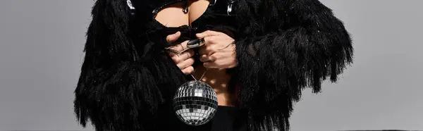 stock image A woman in sexy attire with a fringed jacket and a disco ball.