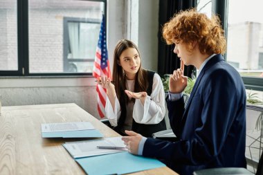 Two teenagers participate in a UN Model simulation, engaging in a passionate discussion. clipart