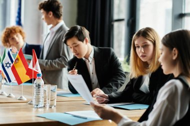 Teenagers participate in a UN Model conference, engaging in serious discussion and debate. clipart