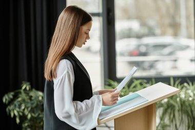 Teenage girl reads her speech during a UN Model conference. clipart