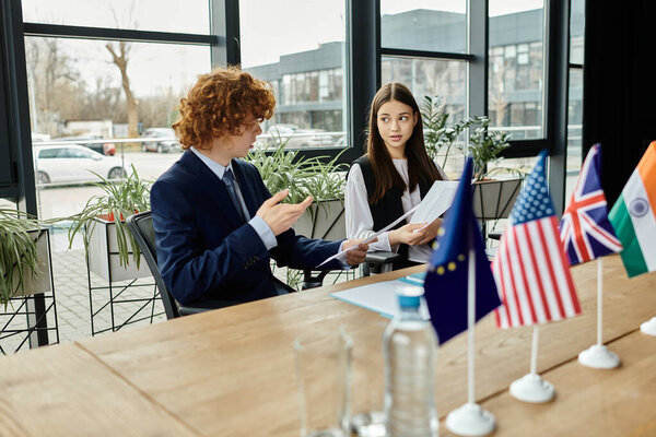 Teenagers participate in a Model UN simulation, engaging in diplomatic discussions.
