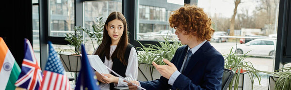 Two teenagers participate in a UN Model conference, discussing international topics.