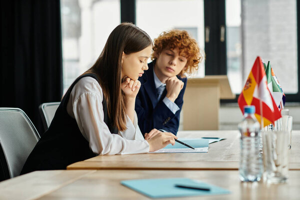 Two teens engage in a UN Model Conference, debating global issues with determination.