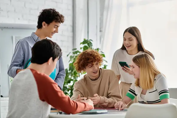 stock image A group of teenagers working together during a UN Model simulation.